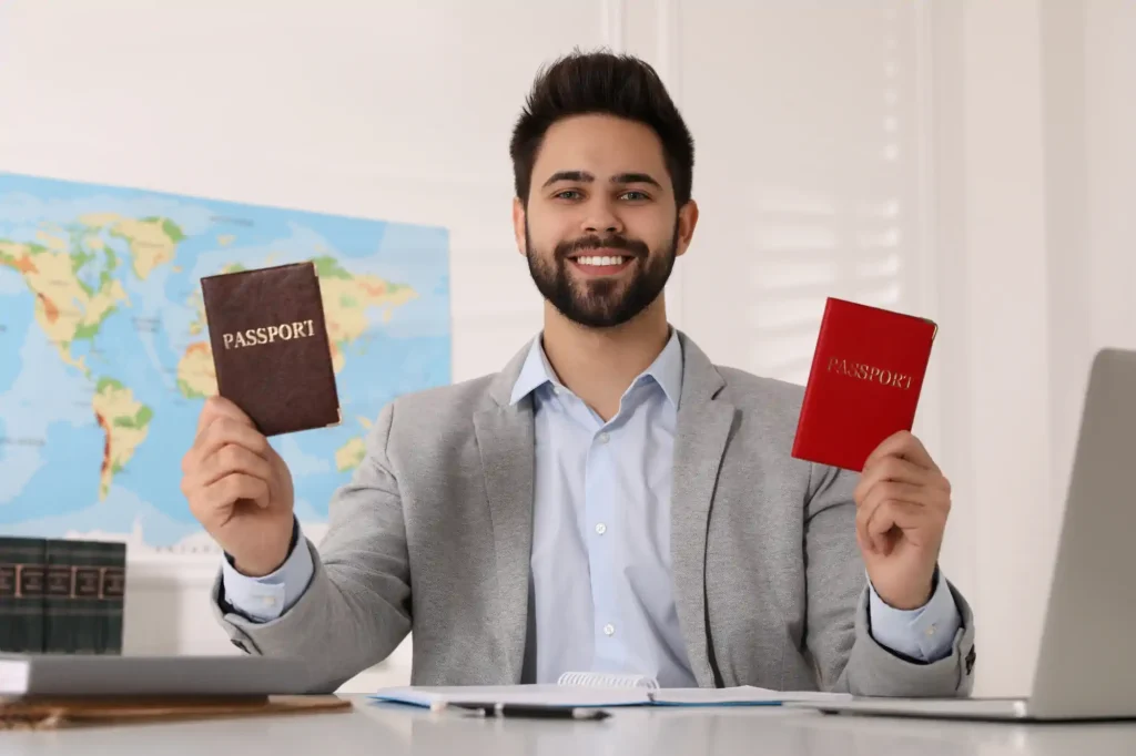 Hombre sonriente mostrando dos pasaportes en oficina