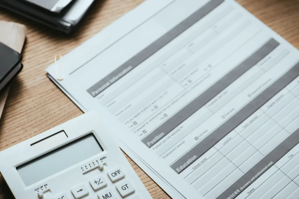 Documento oficial de trámite migratorio junto a una calculadora